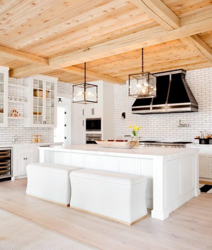 white kitchen with light wood ceilings in this beach house
