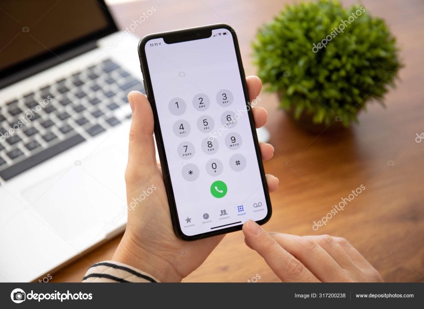 woman hand holding iphone x with call number on screen 317200238